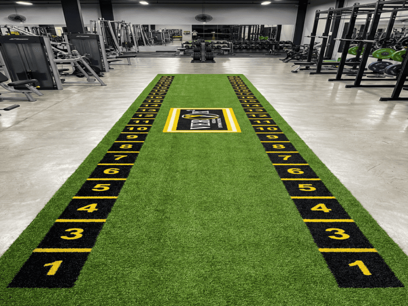 Spreading urethane adhesive on rubber gym mats